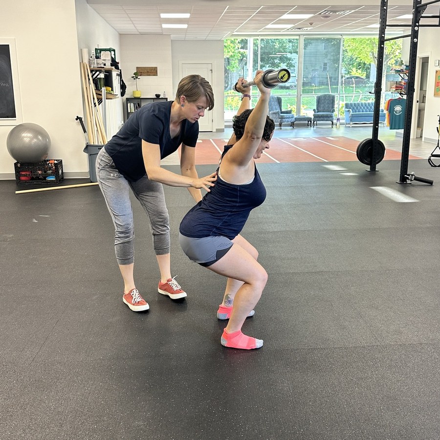 A Perfect Squat coach guiding a kettlebell squat