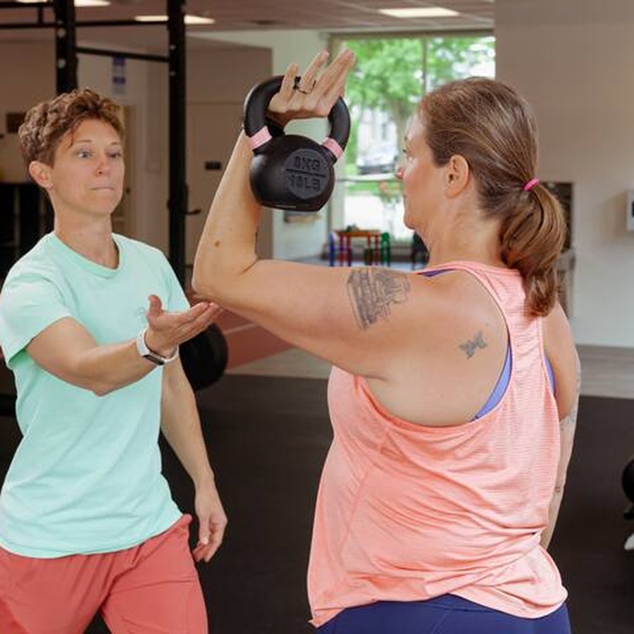 A Perfect Squat coach guiding a kettlebell exercise