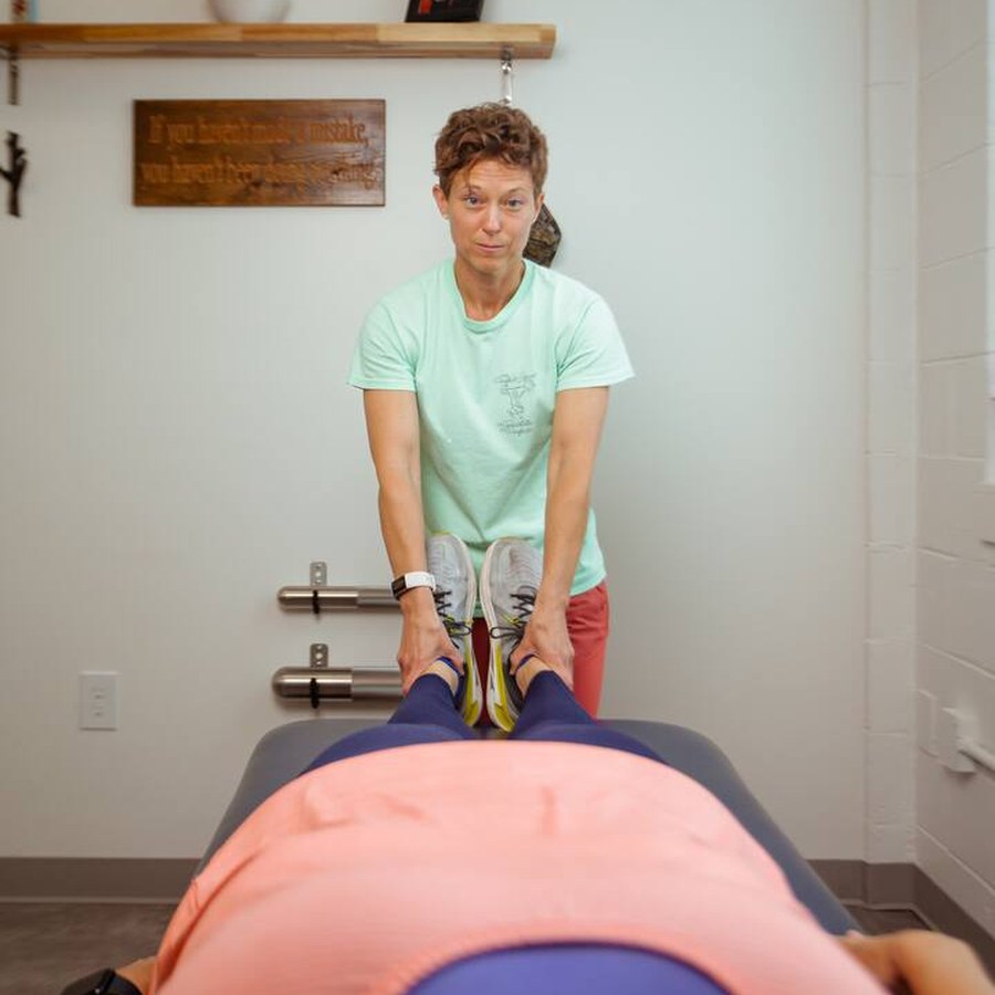 A Perfect Squat physical therapist guiding a client stretch